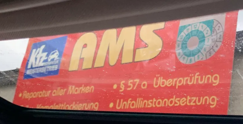 Das rote AMS-Schild mit gelber Schrift: Reparatur aller Marken, §57a Überprüfung, Unfallinstandsetzung